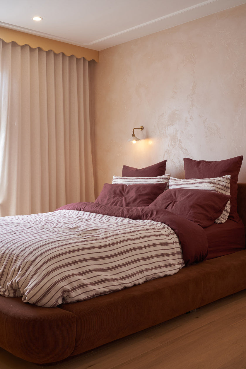 A pink bedroom with a French Flax Linen double sided quilt cover in Cherrywood